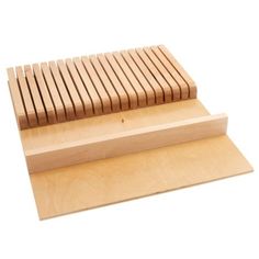 a wooden board with two pieces of wood sitting on it's sides and one piece missing