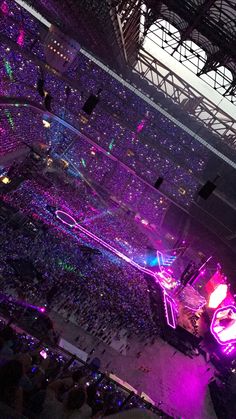 an overhead view of a concert venue with purple lighting and people sitting in the seats