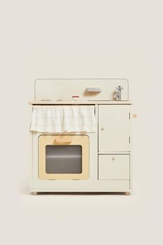 an old fashioned oven with a sink and microwave on it's front door, sitting against a white wall