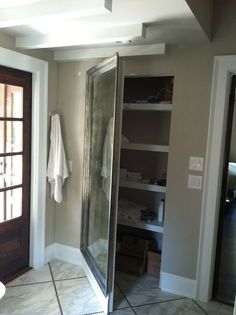 a walk in shower sitting inside of a bathroom next to a door and window on the wall