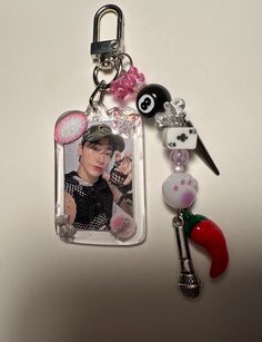 a keychain with a photo and some charms attached to it