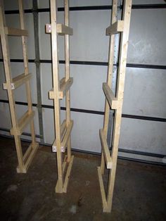 two wooden shelving racks in a room with no one around them and the wall is painted white