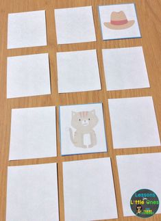 several pieces of paper cut out to look like cats and hats on a table top