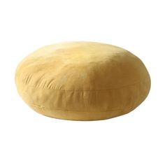 a round yellow pillow on a white background