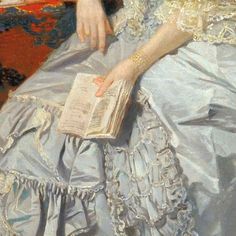 a painting of a woman in a blue dress holding a book while sitting on a couch