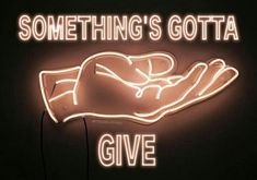 a neon sign that says something's gota give