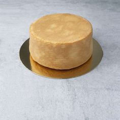 a round cake sitting on top of a metal plate