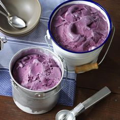 two buckets filled with ice cream sitting on top of a table