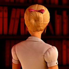 the back of a woman's head in front of a bookcase with books