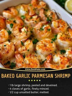 baked garlic parmesan shrimp in a white casserole dish with lemon wedges