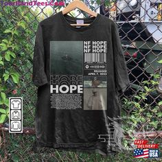 a t - shirt hanging on a chain link fence with the words hope in it