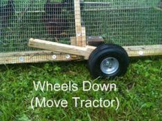 the wheels down move tractor are attached to a fenced in area with green grass