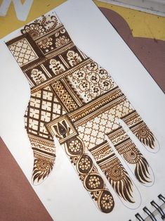 an intricately designed hand is shown on a piece of paper