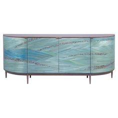 an art deco sideboard with blue and green paint