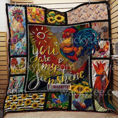 a quilt is hanging on the wall in front of a window with sunflowers and rooster