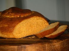 a loaf of bread sitting on top of a wooden cutting board