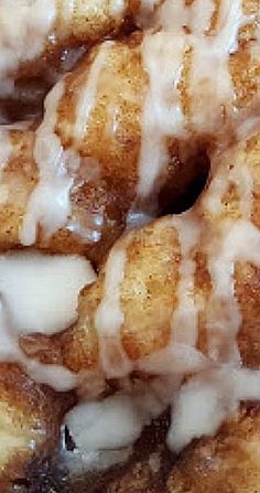 glazed donuts stacked on top of each other with icing drizzled over them