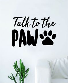 a wall decal that says talk to the paw