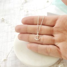 "Beautiful handmade anchor necklace in 925 sterling silver. This delicate necklace is perfect as a gift for a special woman, Christmas gift, beach wedding, bridesmaid, birthday or her special day. ♥ Details: Metal type: Sterling silver Karat / purity: 925 Anchor dimensions: 9.7 x 8.1mm Chain length: 14\", 16\", 18\", 20\". The necklace is 100% handmade. Each necklace takes approximately 2 hours to be ready, so you are buying a piece that was made with love and dedication. All jewelry comes with Minimalist Sterling Silver Jewelry For Beach, Minimalist Silver Jewelry For Beach, Silver Nautical Jewelry With Adjustable Fit, Anchor Shaped Jewelry With Adjustable Chain For Gift, Adjustable Nautical Silver Jewelry, Tiny Sterling Silver Charm Necklace For Her, Delicate Sterling Silver Charm Necklaces With Lobster Clasp, Sterling Silver Necklaces With Adjustable Chain For Bridesmaids, Sterling Silver Necklace With Adjustable Chain For Bridesmaid Gift