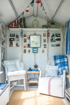 a living room with white furniture and lots of pictures on the wall above it is an orange circle