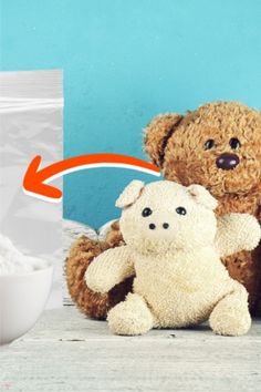 two teddy bears sitting next to each other on a table with powdered sugar in the background