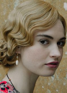 a close up of a person wearing a necklace with flowers on it's neck