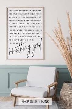 a white chair sitting in front of a wall with a framed quote above it that says something good