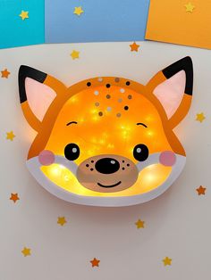 an animal shaped night light with stars on the wall next to it's head