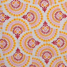 an orange and pink pattern on white fabric