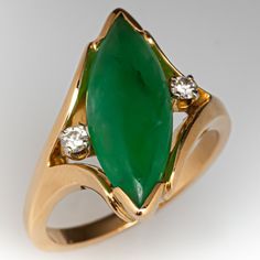 This lovely ring is centered with one (1) marquise cabochon cut natural jadeite jade set with two-chevron prongs. The center stone sits at an angle and is flanked on either side by one (1) round diamond set in a four-prong head. The ring measures 19.7mm at the top, rises 4.9mm above the finger, tapering to 1.8mm wide and 1.6mm thick at the base of the shank. This ring is currently a size 6. Jade Rings, Round Diamond Setting, Garnet Jewelry, Jade Ring, Jade Jewelry, Lovely Ring, Diamond Set, Brilliant Diamond, High Quality Jewelry