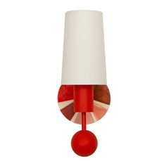 a red lamp with a white shade on it