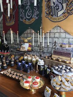 a table with harry potter themed desserts on it