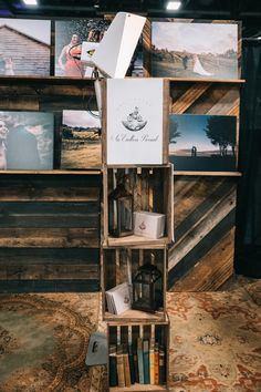 a book shelf with books and pictures on the wall