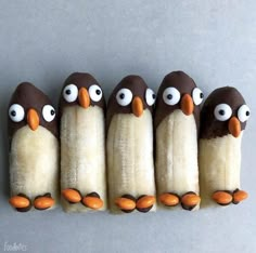 five bananas with googly eyes are arranged in the shape of penguins on top of each other