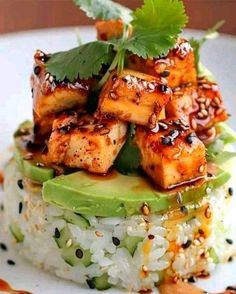 a white plate topped with rice and tofu