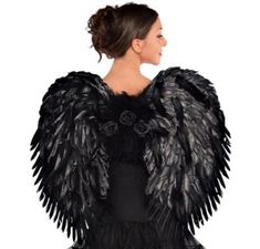 a woman wearing an angel costume with black feathers