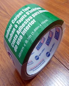 a roll of tape sitting on top of a wooden table