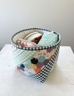 a close up of a cup on a table with some fabric material in the middle