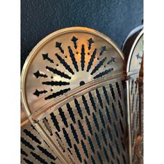 an old metal fan with black arrows on it's back and the top half