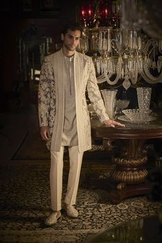 Featuring a silver grey indowestern jacket in silk base with dori embroidery. It is paired with a cotton silk embroidered kurta and stretchable terry rayon straight pants, including a pair of juttis. Perfect wear for an engagement or a sangeet ceremony.#Perniaspopupshopmen #menswear #ethnic #whatiworewastrending #ppuslove #indowesternset #Silk #cottonsilk #engagment #silkembroidery #doriembroidery Indowestern Outfits For Men, Western Outfits For Men, White Straight Pants, Indo Western Outfits For Men, Indo Western Dress For Men, Indian Wedding Suits Men, Indian Wedding Clothes For Men, Dori Embroidery, Seema Gujral