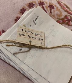 an envelope with a note attached to it and some writing on the front is tied up