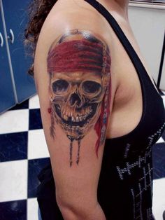 a woman with a pirate skull tattoo on her arm and shoulder, wearing a red bandana