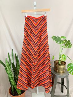 "1960s rainbow skirt. Chevron stripe going down middle. A line maxi skirt with red, yellow, green, blue and white. Side metal zipper, side plastic green button. High waist.  Tag: none.  SIZE  Modern size: XXS Waist: 22\" Hip: 34\" Length: 41\" Measurements are taken with the garment lying flat, and un-stretched. Bust, waist and hip measurements are doubled. Sleeves are measured from shoulder seam to cuff. Please remember that these are not body measurements, so leave room for comfort. We suggest that you measure a well-fitting garment to find measurements right for you.  CONDITION  This item is in Very Good condition. There's a small section of loose seam towards the hem of the skirt. Just a bit of thread will fix this. See last photo. Condition Guide: New: Never worn, no flaws Excellent: A Line Maxi Skirt, Colorful Knit, Rainbow Skirt, Skirt A Line, Skirt High Waist, Chevron Stripe, Green Button, Stripe Skirt, Metal Zipper