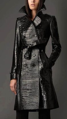 Introducing our custom-made Women's Alligator Embossed Black Leather Trench Long Coat - a stunning and tailored masterpiece designed for those who appreciate bold fashion and a perfect fit. This double-breasted trench coat, embossed with an alligator pattern, offers a unique blend of style and sophistication for the discerning woman. Material: Crafted from high-quality black leather with an alligator embossed texture, this trench coat exudes a luxurious and distinctive charm. The custom sizing ensures that the coat is tailored to perfection, providing a comfortable and flattering fit for plus-sized individuals. Design: The double-breasted design, coupled with the collar detailing, gives this coat a classic and timeless allure. The carefully placed buttons and the waist belt add both functi Goth Corsets, Leather Dress Coat, Leather Clothes, Toxic Vision, Fashion Goth, Long Leather Coat, Goth Style, Womens Jackets, Style Punk