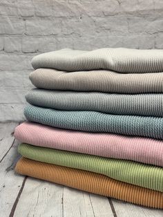 a stack of folded towels sitting on top of each other