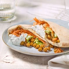 a pita sandwich with chickpeas, carrots and guacamole