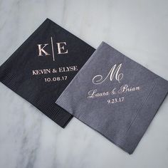 two personalized napkins with monogrammed names on them sitting on a marble surface