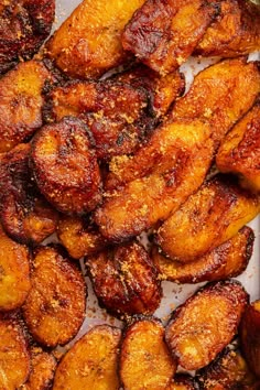 some fried bananas are sitting in a white tray on the table and ready to be eaten