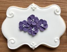 there is a decorated cookie with purple flowers on it