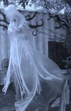 an old photo of a woman in a ghost costume